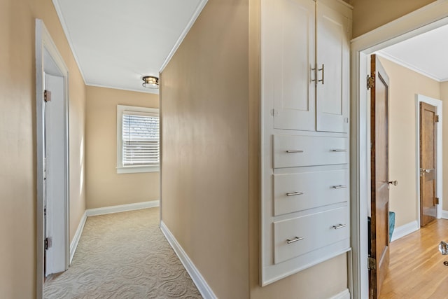 corridor featuring light carpet and ornamental molding