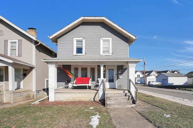 view of front facade featuring a front yard and covered porch