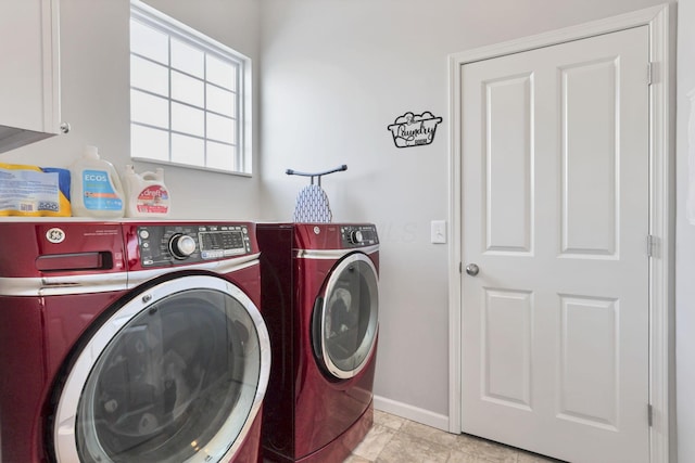 laundry room with cabinets and washer and clothes dryer