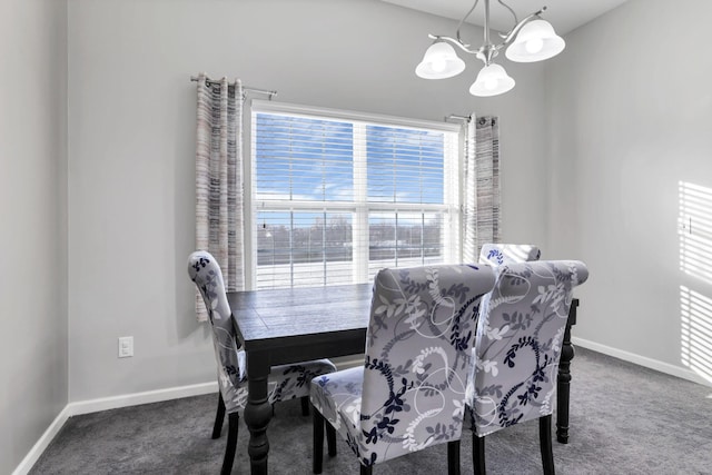 dining space with dark colored carpet and an inviting chandelier