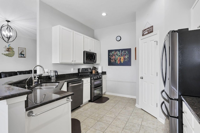 kitchen with decorative light fixtures, sink, white cabinets, light tile patterned flooring, and stainless steel appliances