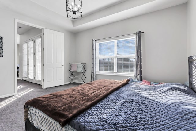 carpeted bedroom with a chandelier