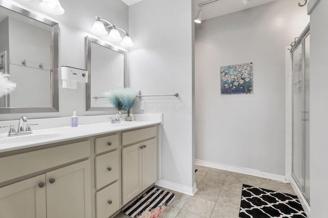 bathroom with tile patterned flooring, walk in shower, and vanity