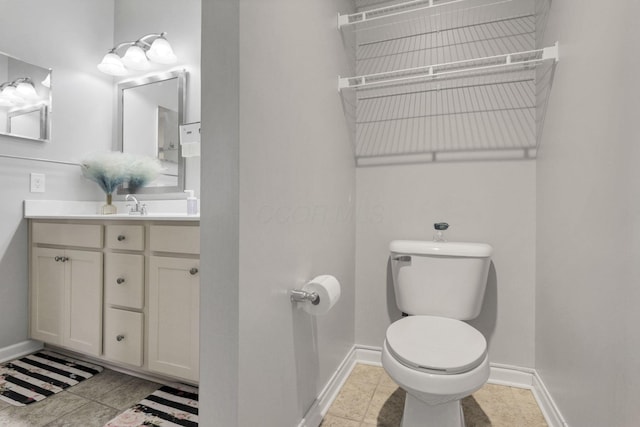 bathroom featuring toilet, tile patterned flooring, and vanity