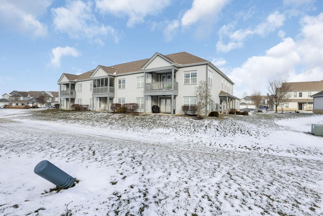 view of snow covered rear of property