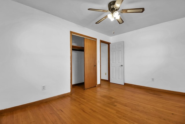 unfurnished bedroom featuring ceiling fan, hardwood / wood-style floors, and a closet