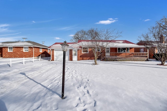 view of snow covered rear of property