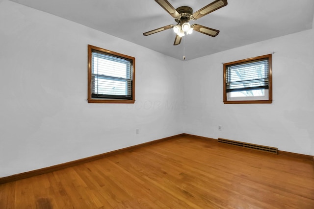 spare room with hardwood / wood-style flooring and ceiling fan