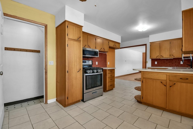 kitchen featuring sink, stainless steel appliances, and tasteful backsplash