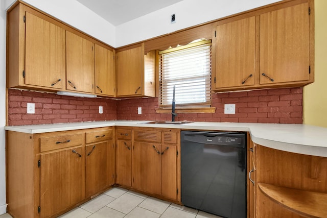 kitchen featuring sink, backsplash, light tile patterned floors, and black dishwasher