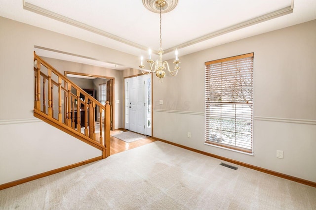 interior space featuring an inviting chandelier and a tray ceiling