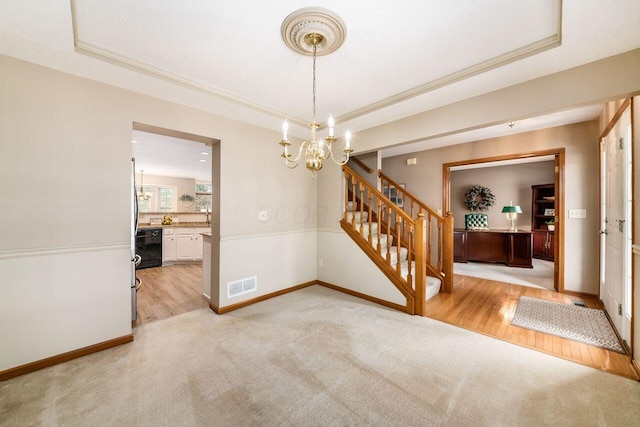 interior space featuring a chandelier and a raised ceiling