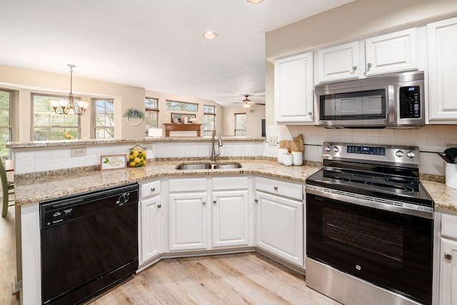 kitchen featuring sink, light hardwood / wood-style flooring, white cabinets, and appliances with stainless steel finishes