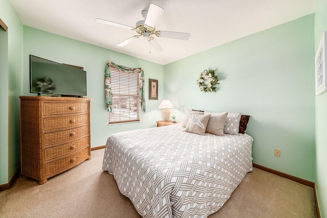 bedroom with ceiling fan and light carpet