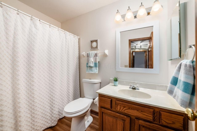 bathroom with vanity, hardwood / wood-style floors, and toilet