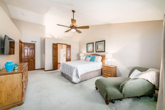 bedroom with light carpet, vaulted ceiling, and ceiling fan