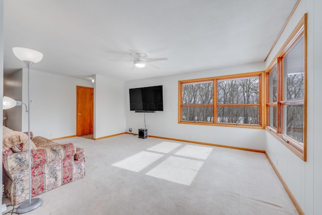 unfurnished living room with ceiling fan and light carpet