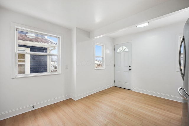 entrance foyer featuring a wealth of natural light and light hardwood / wood-style flooring