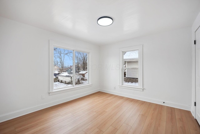 spare room featuring light wood-type flooring