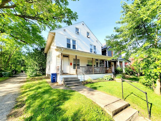 view of front of property with covered porch and a front lawn