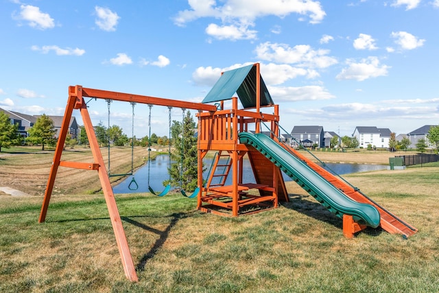 view of playground featuring a yard and a water view