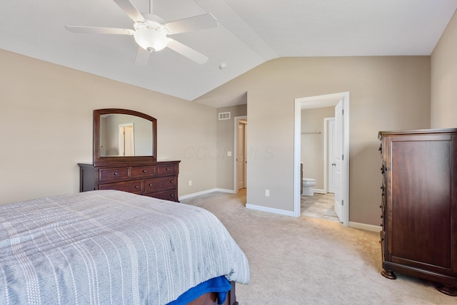 carpeted bedroom featuring ensuite bathroom, vaulted ceiling, and ceiling fan