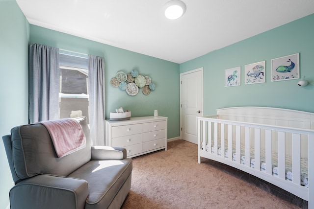 carpeted bedroom featuring a crib