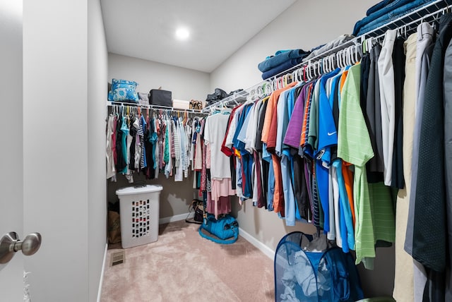 walk in closet featuring carpet flooring