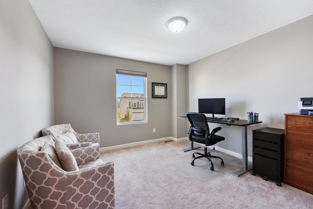 office space featuring a textured ceiling and light carpet