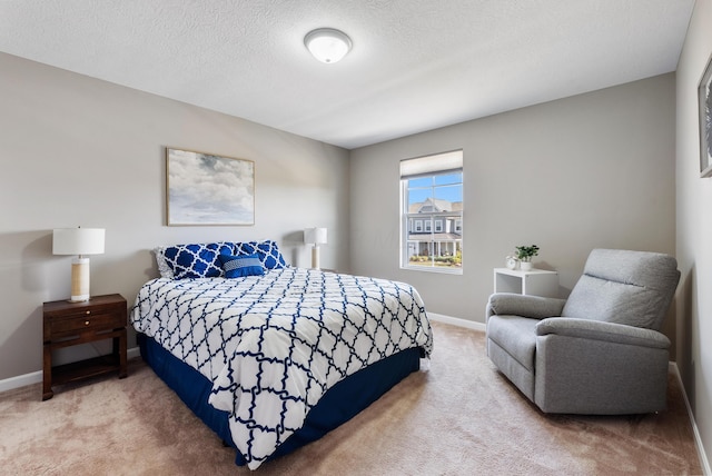 bedroom with a textured ceiling and carpet flooring