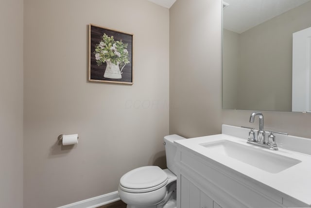 bathroom with toilet and vanity