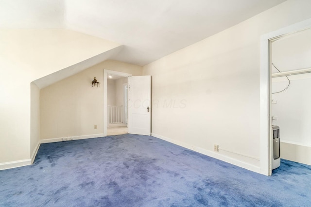 additional living space with lofted ceiling and carpet flooring