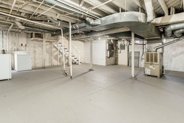 basement with separate washer and dryer, heating unit, and electric panel