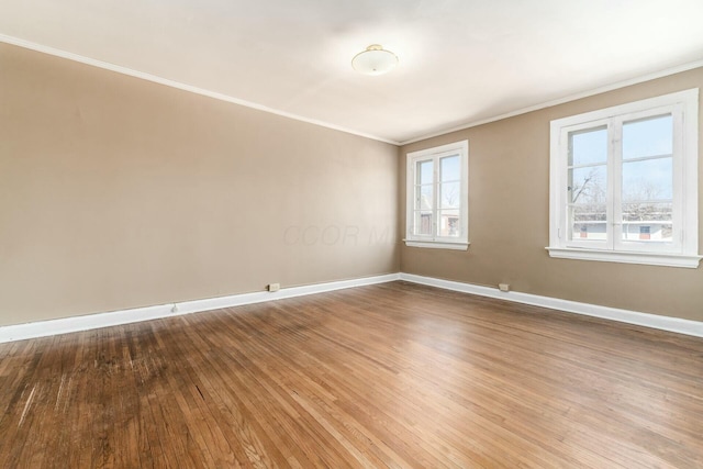 unfurnished room with crown molding and hardwood / wood-style flooring