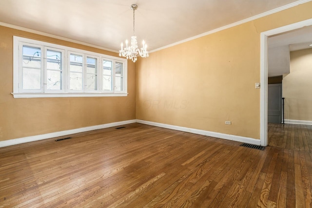 unfurnished dining area featuring crown molding, hardwood / wood-style floors, and a chandelier