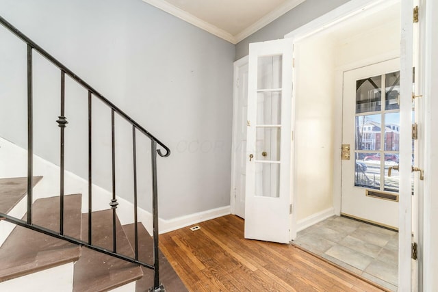 foyer entrance featuring ornamental molding and hardwood / wood-style floors