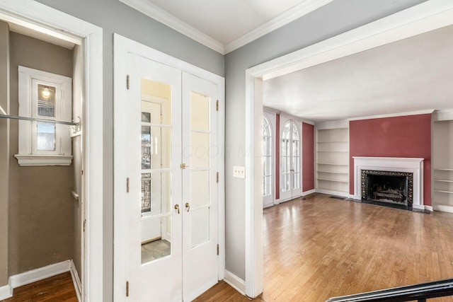 interior space with a healthy amount of sunlight, ornamental molding, and wood-type flooring