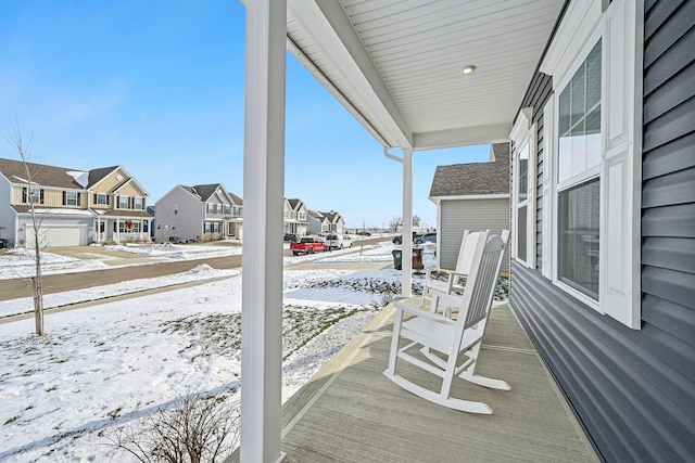 snow covered patio with a porch