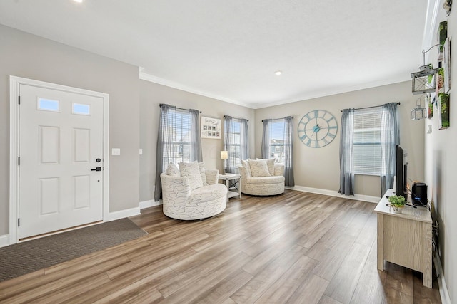 foyer entrance with hardwood / wood-style flooring and ornamental molding