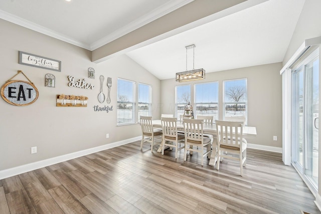 dining room with light wood-type flooring and vaulted ceiling with beams