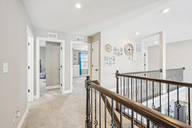 corridor featuring light colored carpet