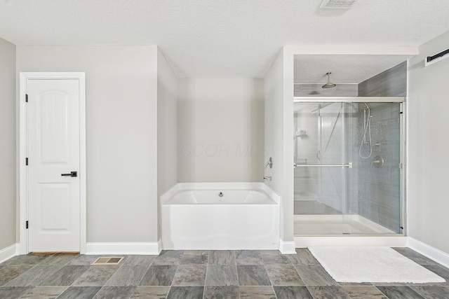 bathroom with a textured ceiling and plus walk in shower