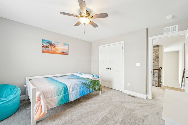 bedroom featuring a closet, ceiling fan, and light colored carpet