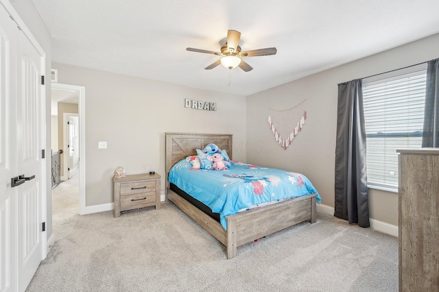 bedroom featuring ceiling fan and light carpet