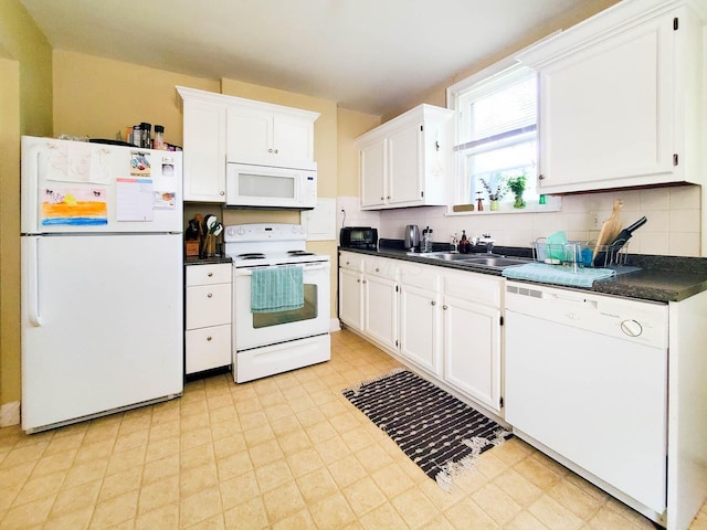 kitchen featuring white cabinetry, sink, white appliances, and decorative backsplash