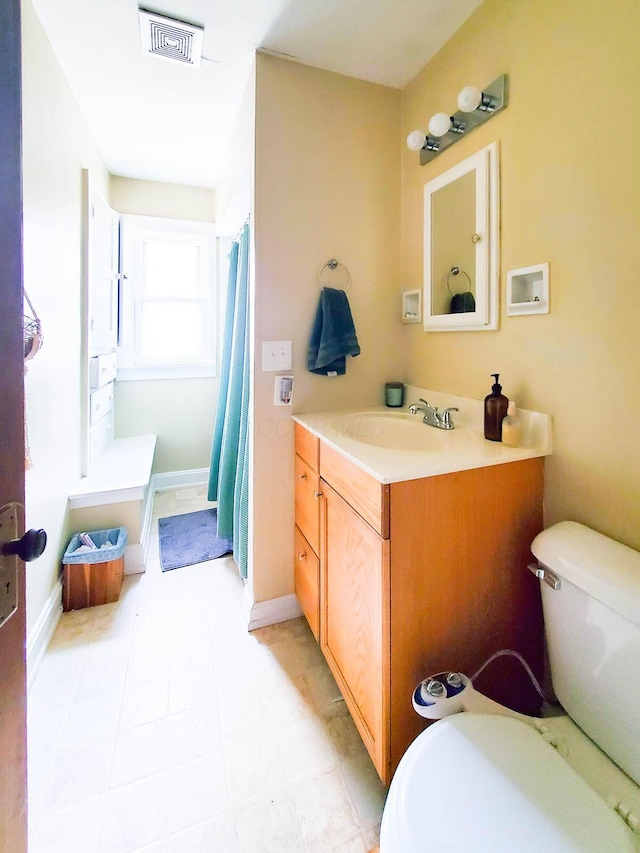 bathroom with vanity and toilet