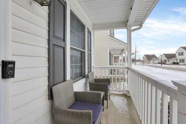 view of snow covered back of property