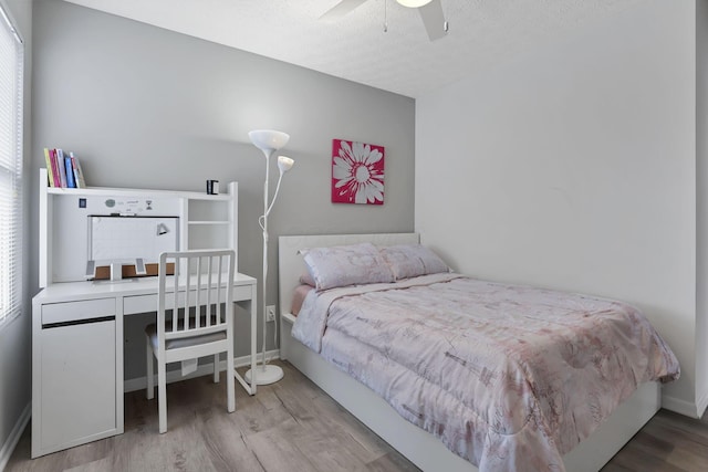 bedroom with hardwood / wood-style flooring and ceiling fan