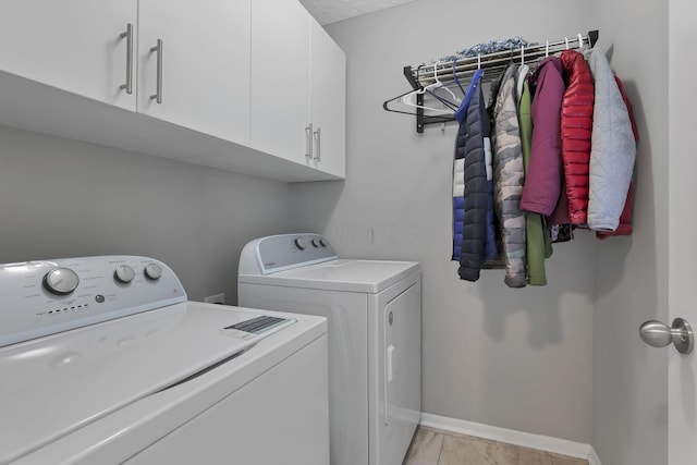 laundry room featuring cabinets and washing machine and dryer