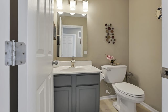 bathroom featuring toilet, tile patterned flooring, and vanity